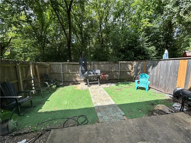 a view of a backyard with swimming pool