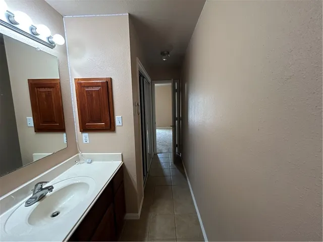 a bathroom with a sink a mirror and a toilet