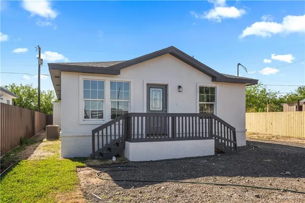 a view of a house with a yard and deck