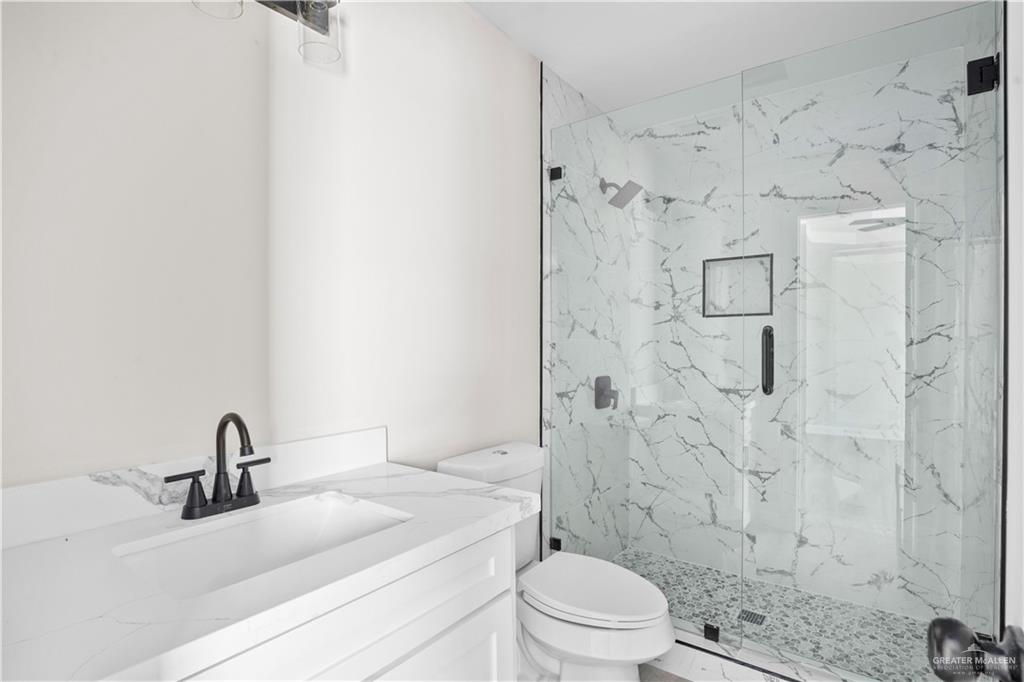 1343 Middle Street Alamo, TX 78516 - Photo 11 of 17 a bathroom with a sink toilet a mirror and shower