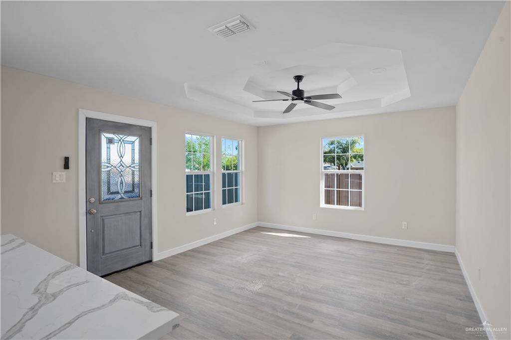 1343 Middle Street Alamo, TX 78516 - Photo 3 of 17 a view of an empty room with a window and wooden floor