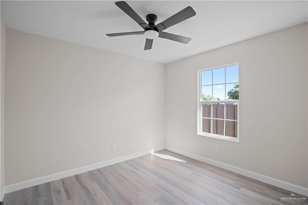 1343 Middle Street Alamo, TX 78516 - Photo 10 of 17 an empty room with window and a ceiling fan