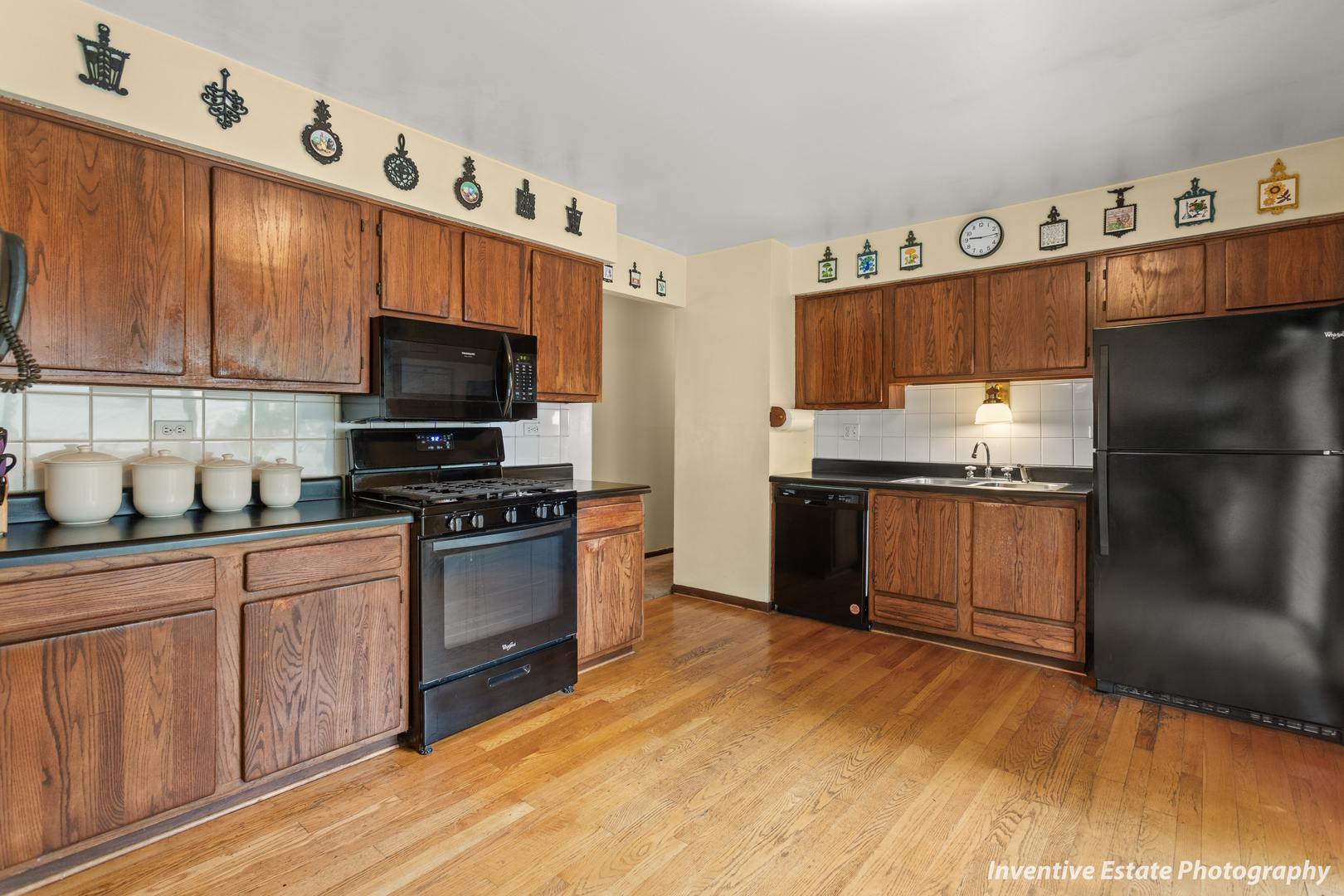 359 Galahad Road Bolingbrook, IL 60440 - Photo 11 of 22 a kitchen with granite countertop a refrigerator and a stove top oven