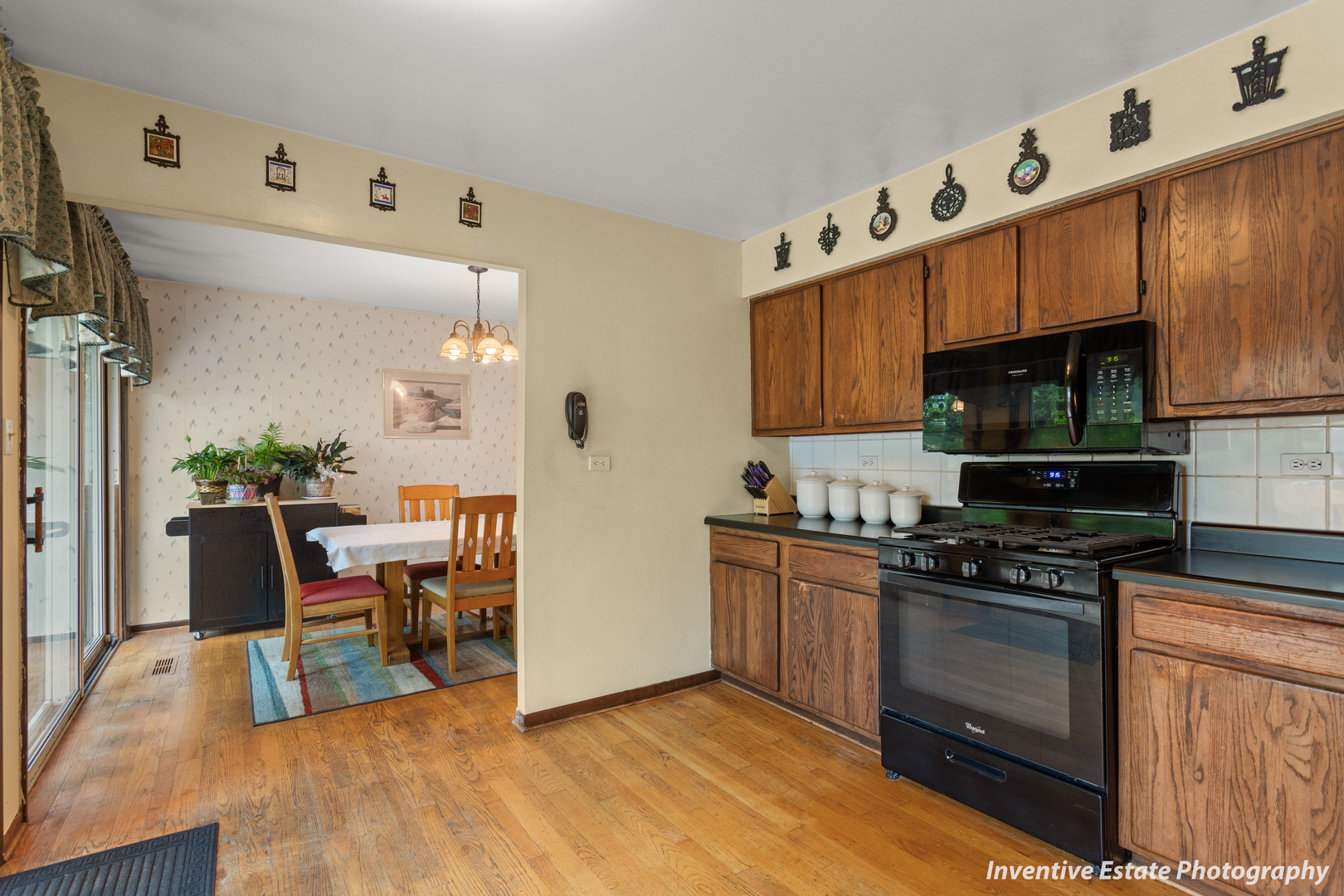359 Galahad Road Bolingbrook, IL 60440 - Photo 10 of 22 a kitchen with granite countertop a stove top oven a sink dishwasher and white cabinets with wooden floor