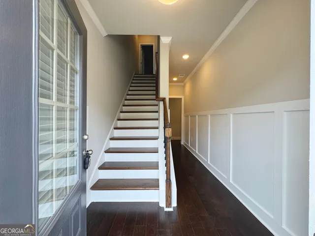 a view of entryway with wooden floor and windows