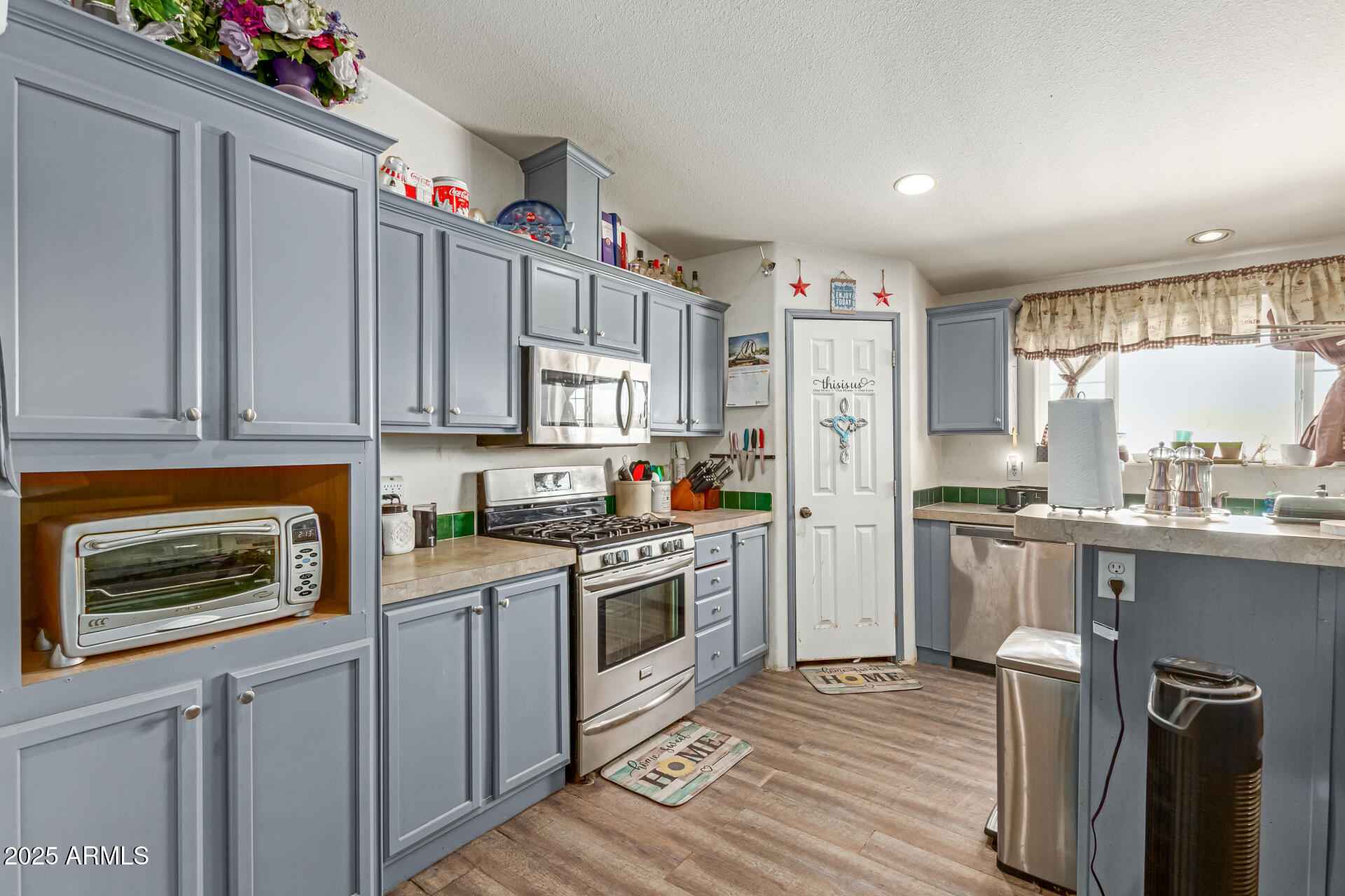 1347 South Oak Road Maricopa, AZ 85139 - Photo 11 of 30 a kitchen with granite countertop a refrigerator stove and sink