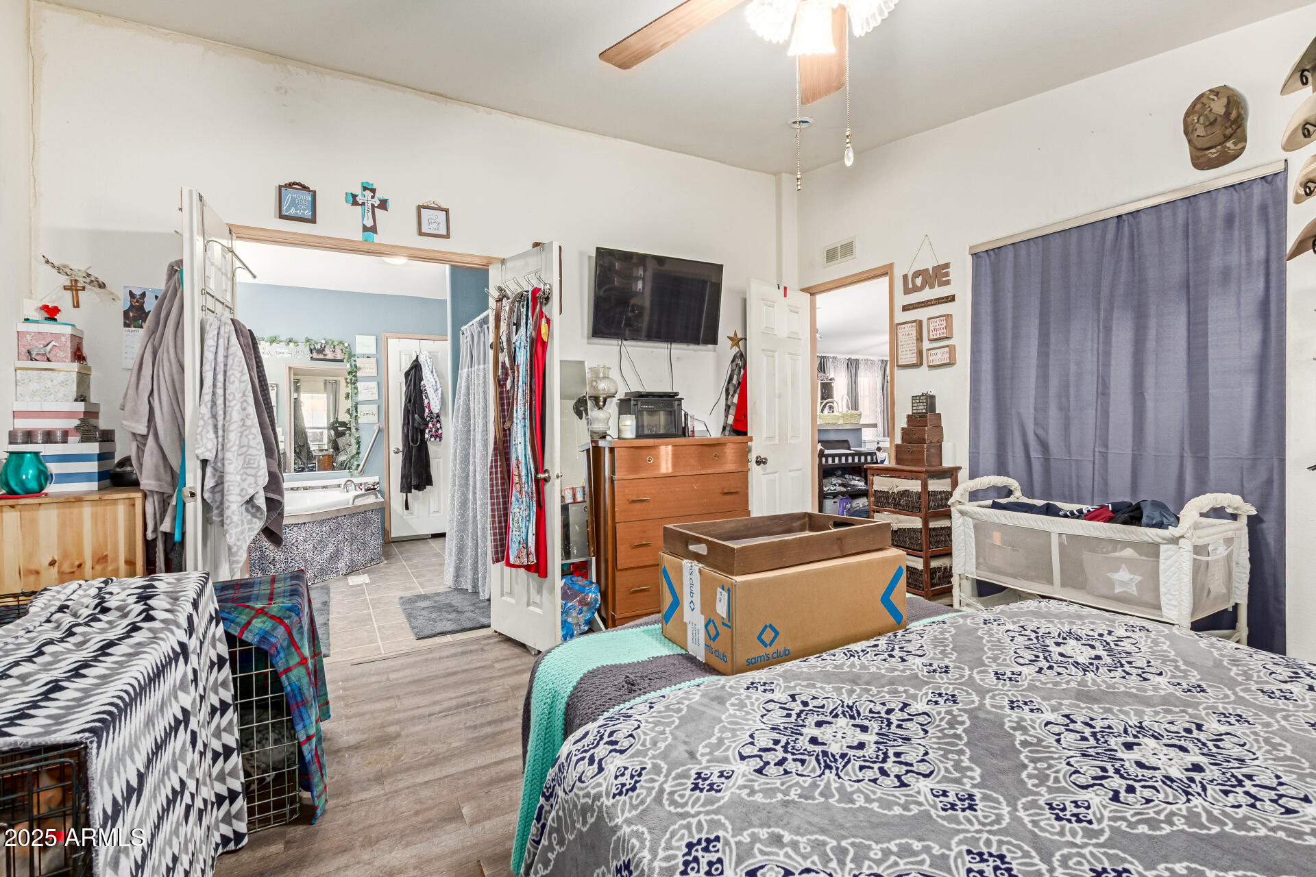 1347 South Oak Road Maricopa, AZ 85139 - Photo 14 of 30 a bed room with furniture and a flat screen tv