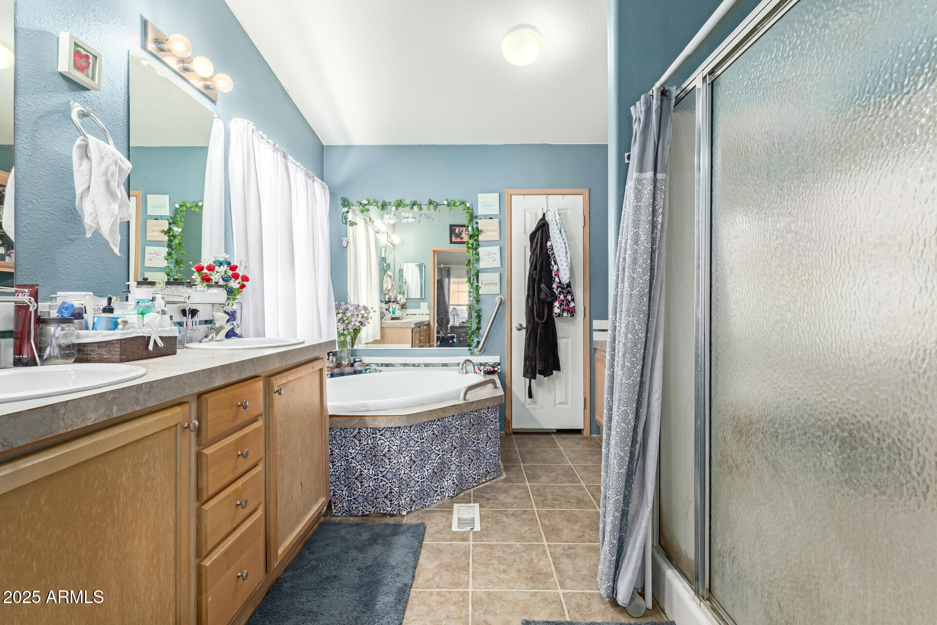 1347 South Oak Road Maricopa, AZ 85139 - Photo 15 of 30 a bathroom with a double vanity sink a large mirror and shower