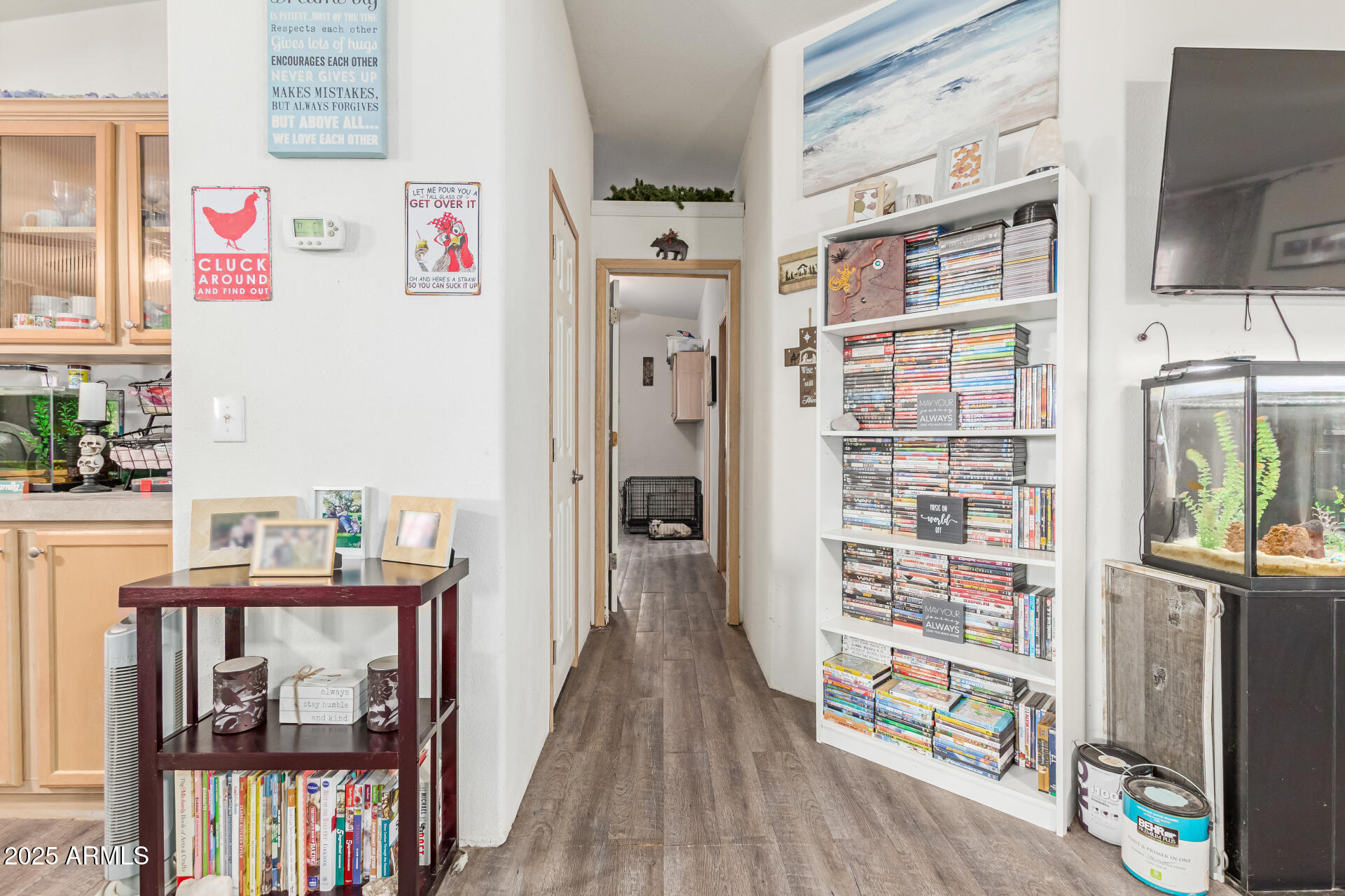 1347 South Oak Road Maricopa, AZ 85139 - Photo 17 of 30 a view of a hallway with wooden floor and dining room
