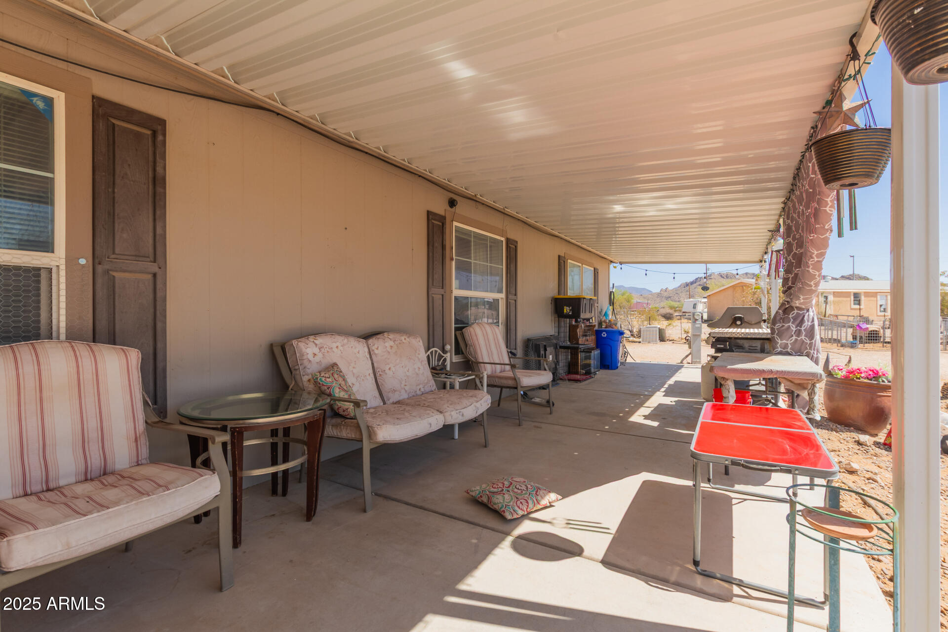 1347 South Oak Road Maricopa, AZ 85139 - Photo 5 of 30 a living room with furniture a rug and white walls