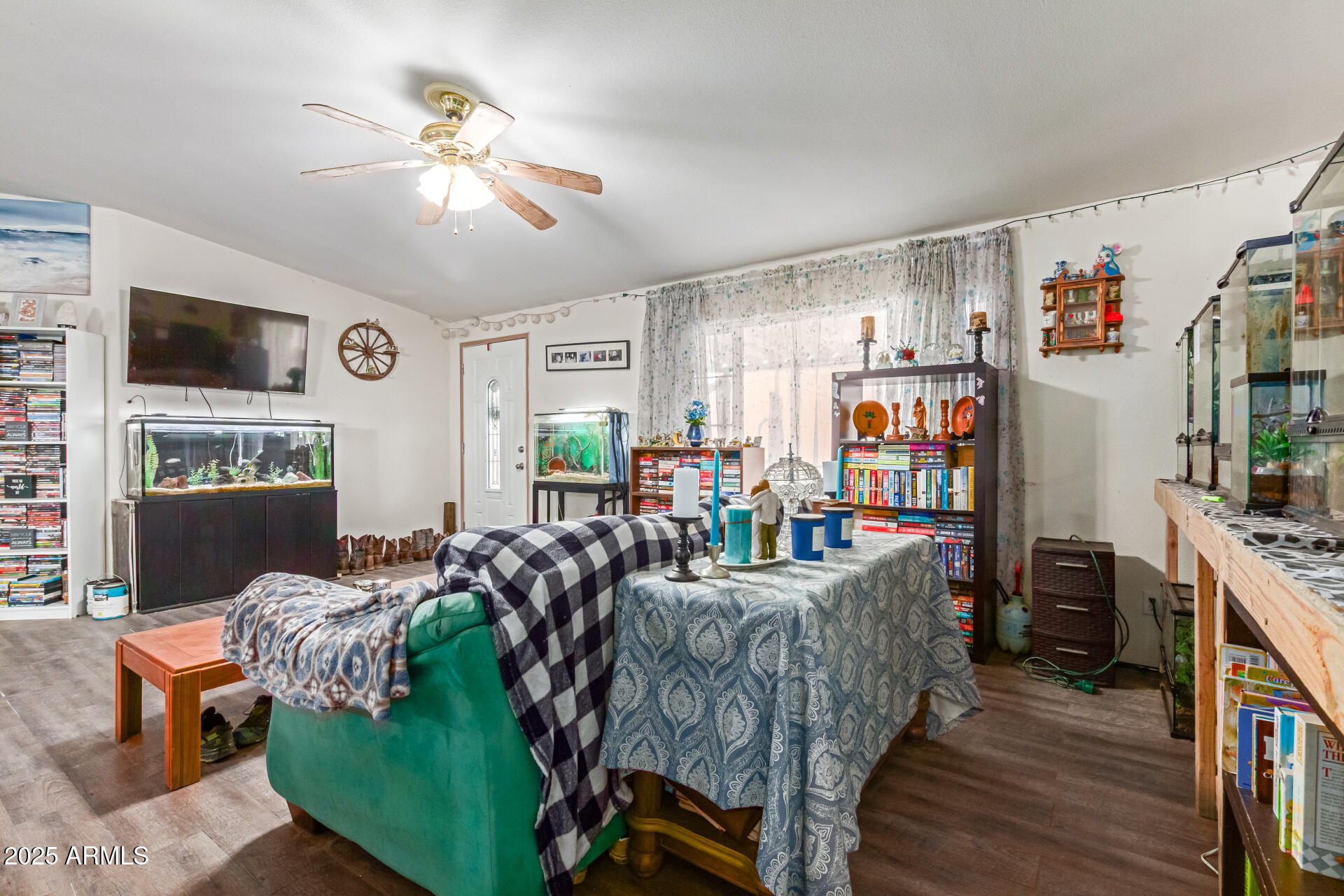 1347 South Oak Road Maricopa, AZ 85139 - Photo 7 of 30 a living room with furniture and a flat screen tv