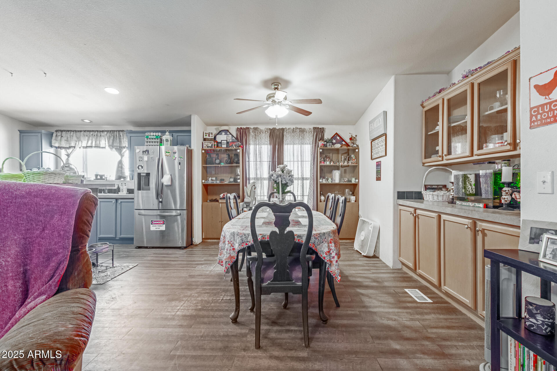 1347 South Oak Road Maricopa, AZ 85139 - Photo 8 of 30 a view of a dining room with furniture window and wooden floor