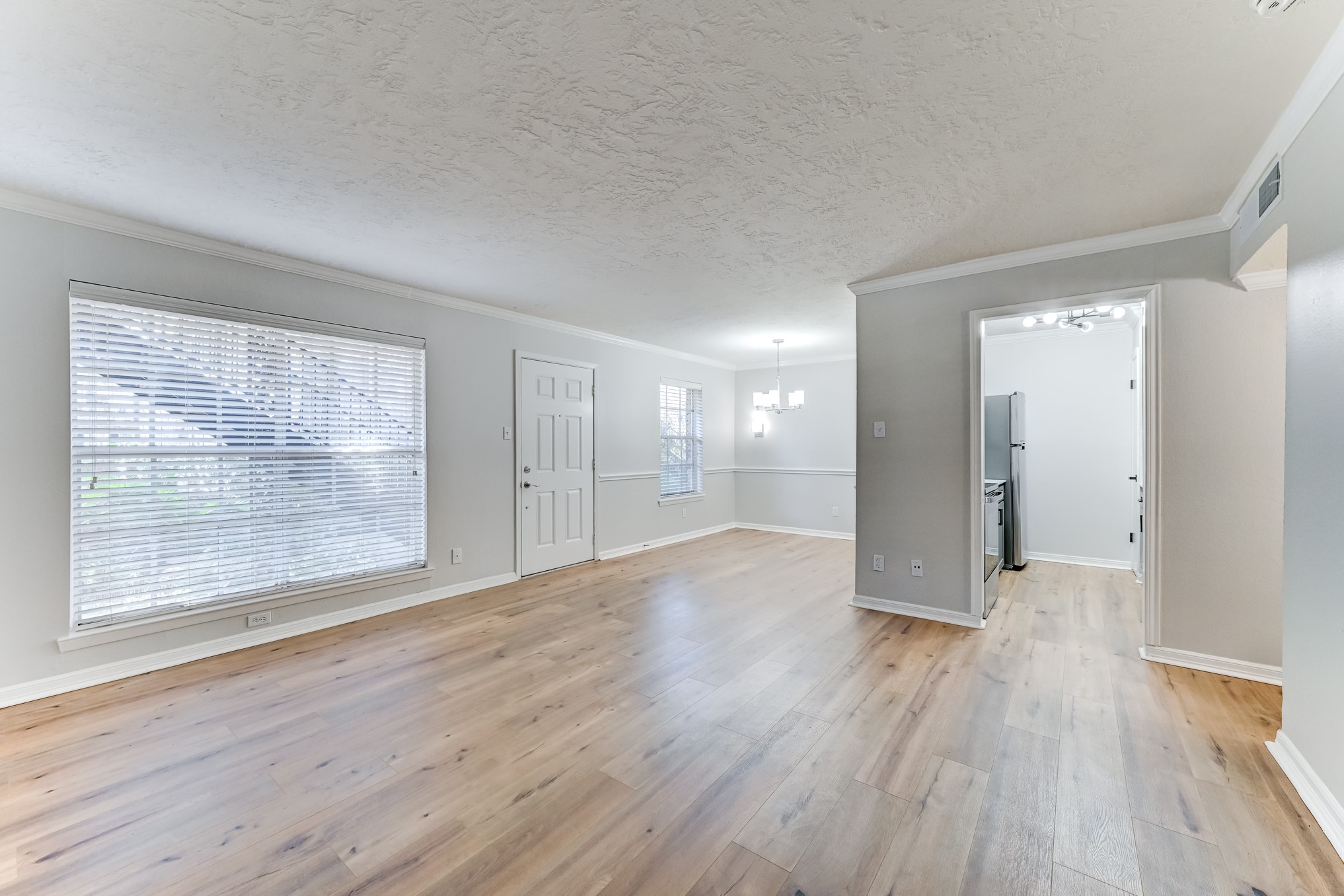 3224 Timmons Lane, Unit 157 Houston, TX 77027 - Photo 11 of 30 a view of wooden floor and windows in an empty room