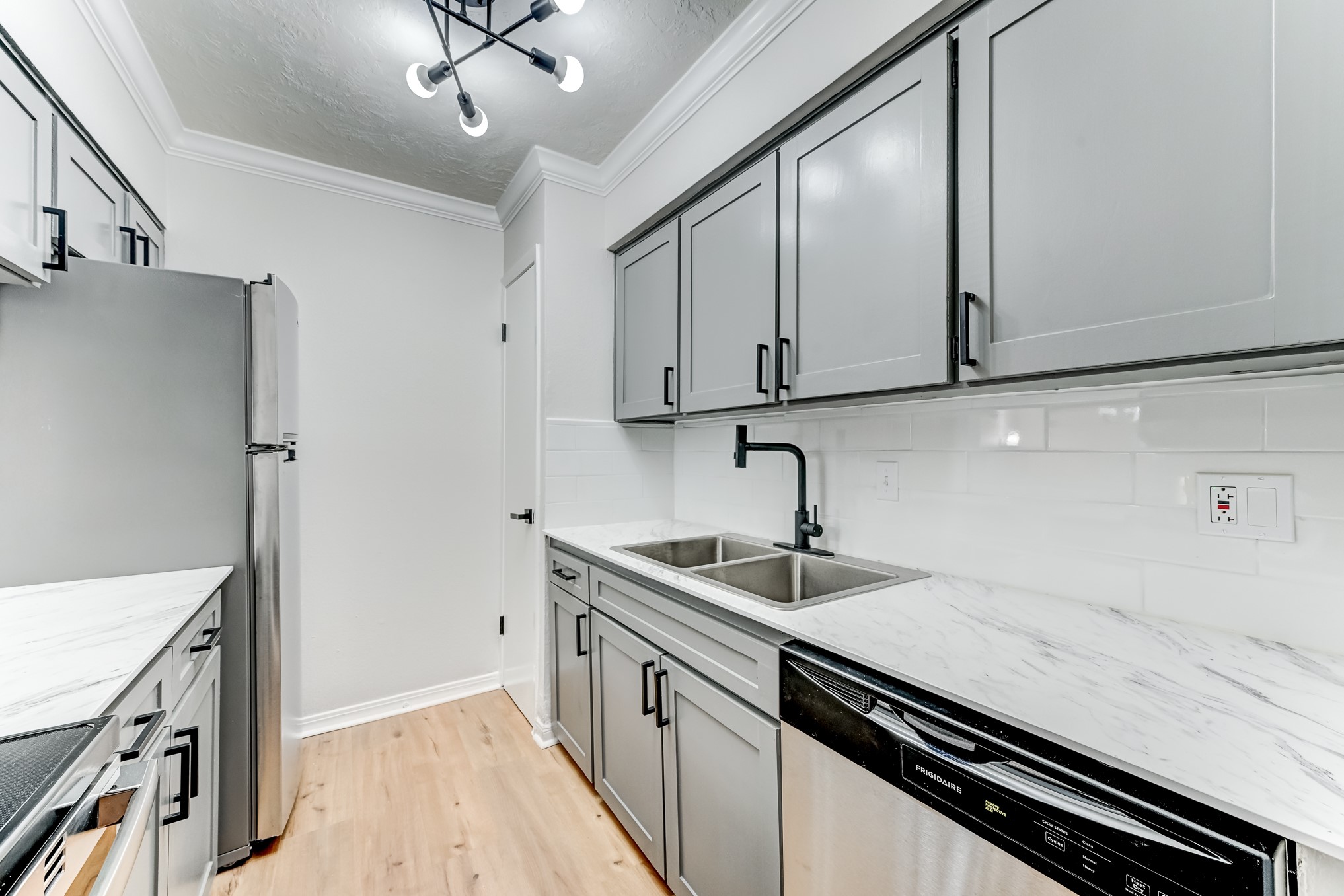 3224 Timmons Lane, Unit 157 Houston, TX 77027 - Photo 15 of 30 a kitchen with stainless steel appliances a sink stove and cabinets