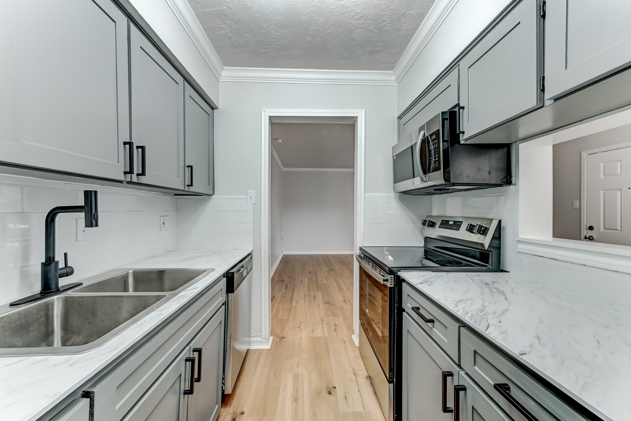 3224 Timmons Lane, Unit 157 Houston, TX 77027 - Photo 16 of 30 a kitchen with stainless steel appliances granite countertop a sink a stove and cabinets