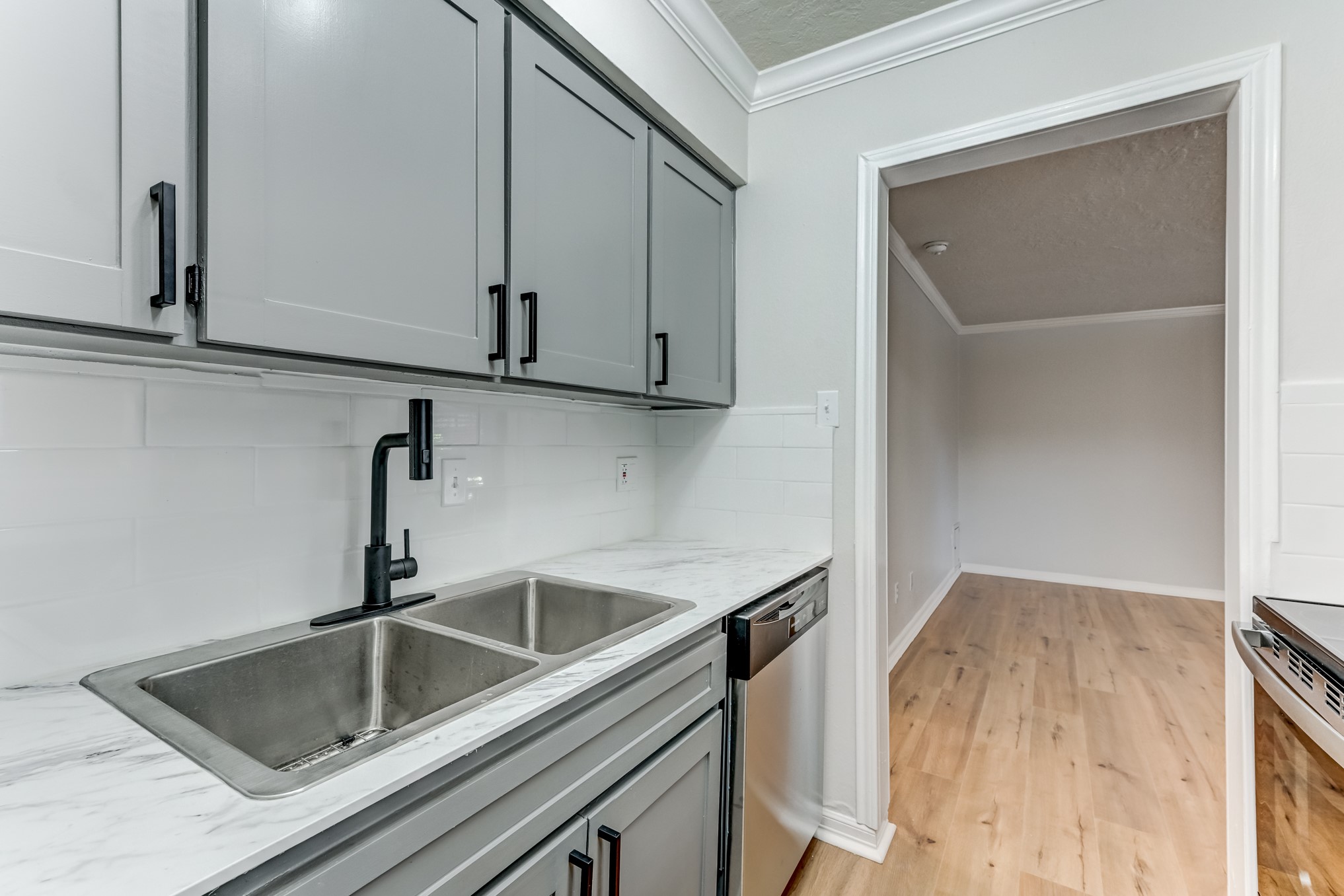 3224 Timmons Lane, Unit 157 Houston, TX 77027 - Photo 17 of 30 a kitchen with a sink and cabinets