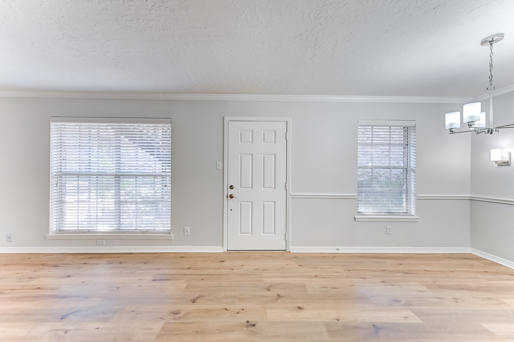 3224 Timmons Lane, Unit 157 Houston, TX 77027 - Photo 4 of 30 an empty room with wooden floor cabinet and windows