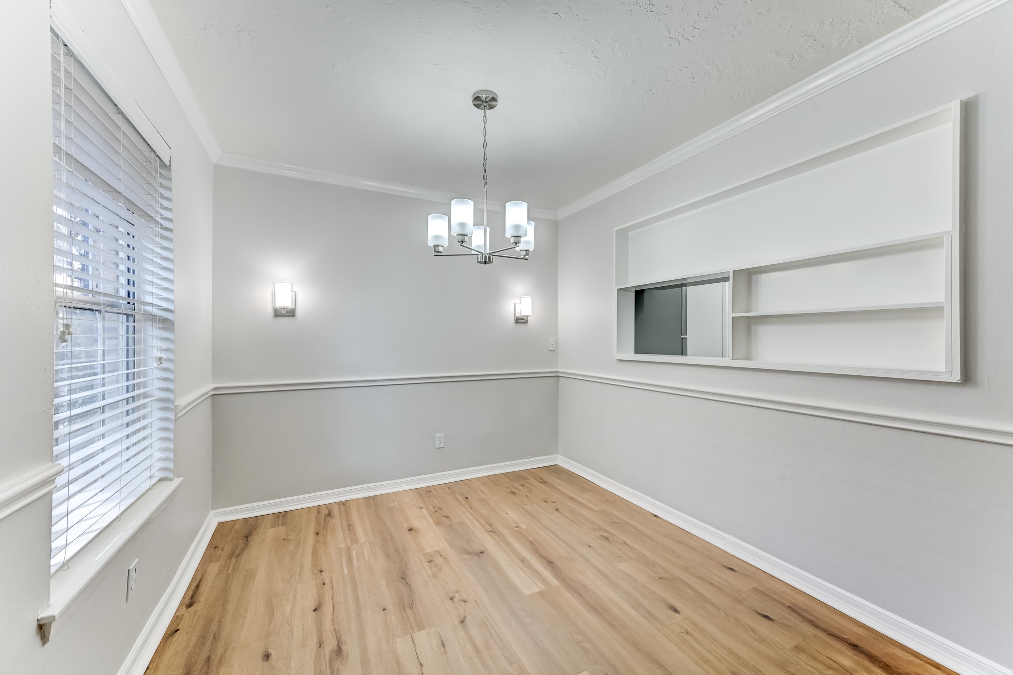 3224 Timmons Lane, Unit 157 Houston, TX 77027 - Photo 5 of 30 a view of a room with wooden floor and chandelier