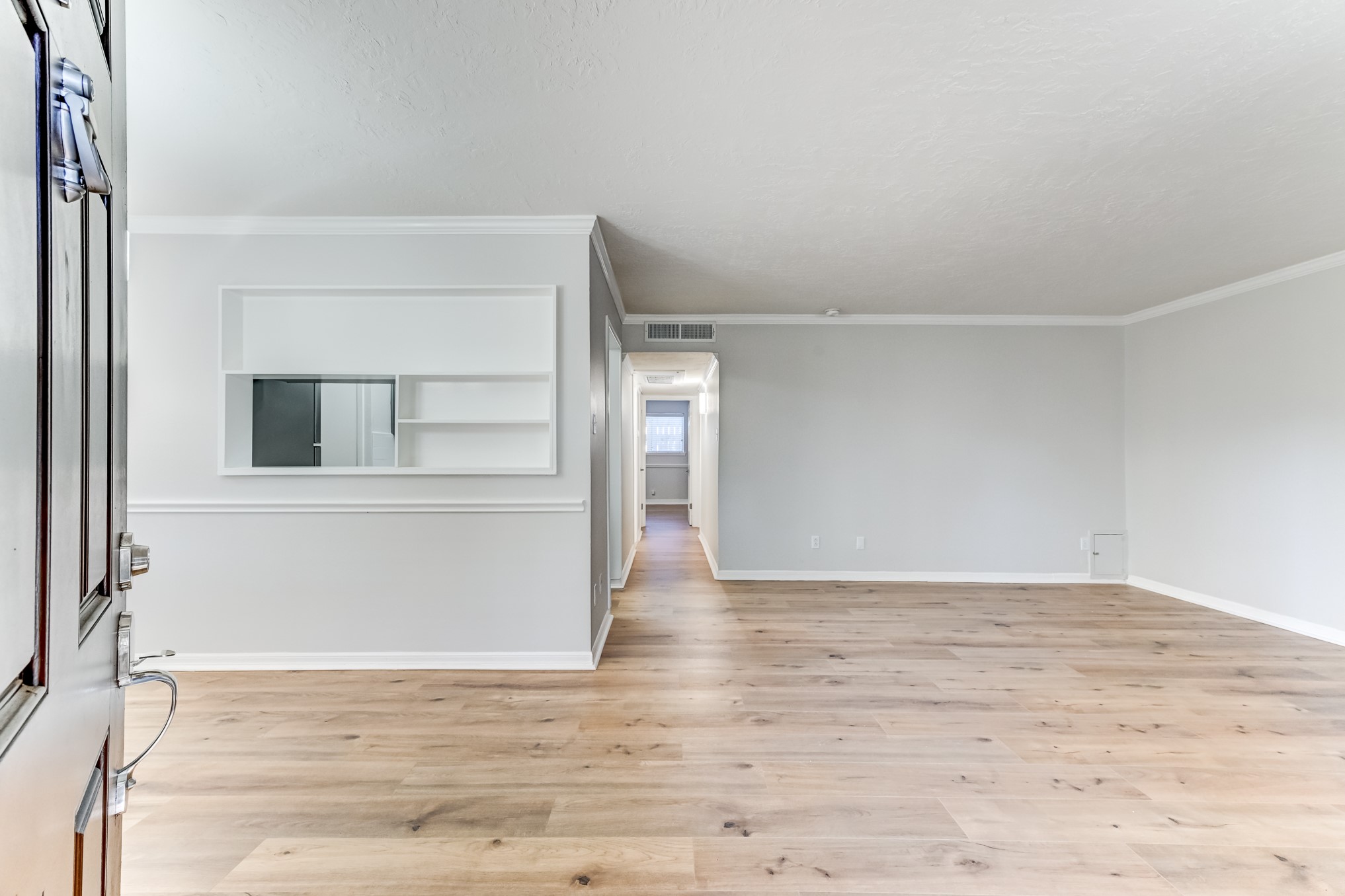 3224 Timmons Lane, Unit 157 Houston, TX 77027 - Photo 6 of 30 a view of an empty room with wooden floor and a window
