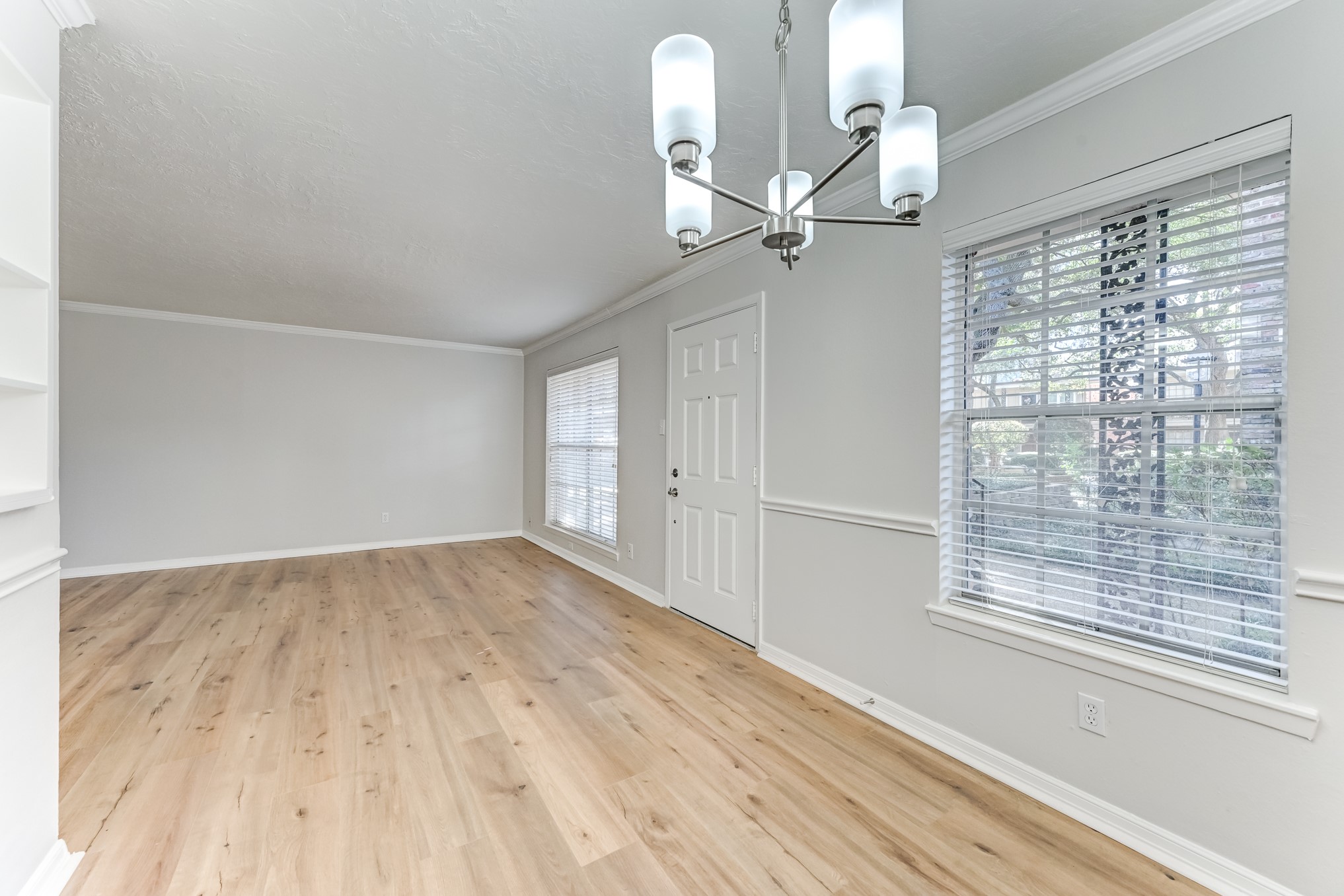 3224 Timmons Lane, Unit 157 Houston, TX 77027 - Photo 7 of 30 a view of empty room with wooden floor and fan