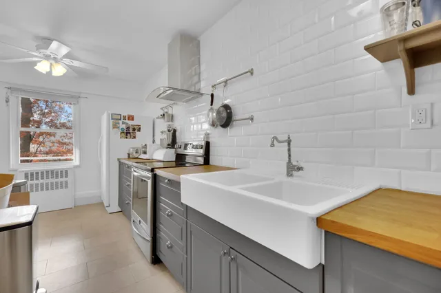 a kitchen with a sink a stove and a refrigerator