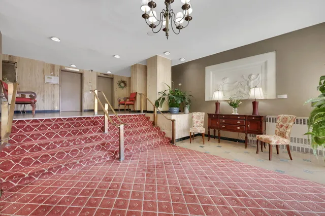 a living room with furniture and a chandelier