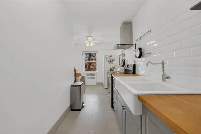 a kitchen with cabinets and wooden floor
