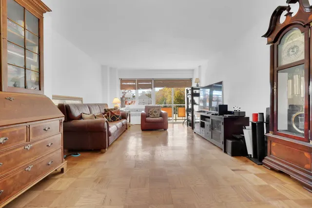 a living room with furniture and a open closet