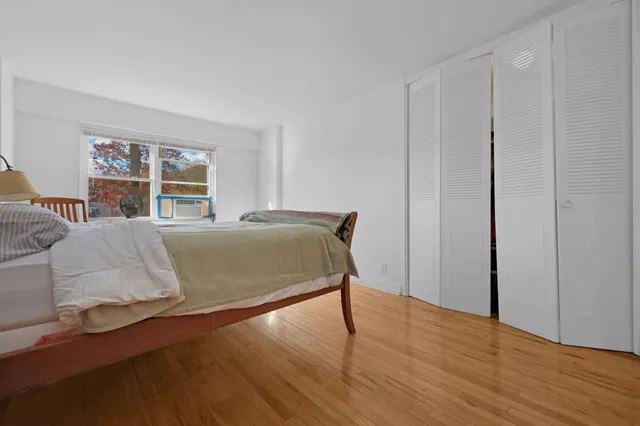 a bed sitting in a bedroom next to a window