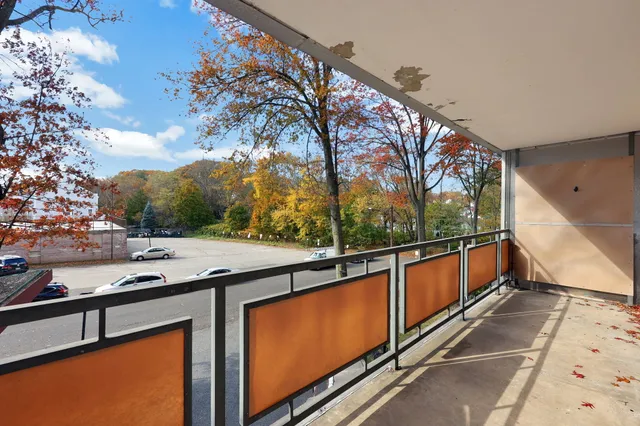 a view of a balcony with trees