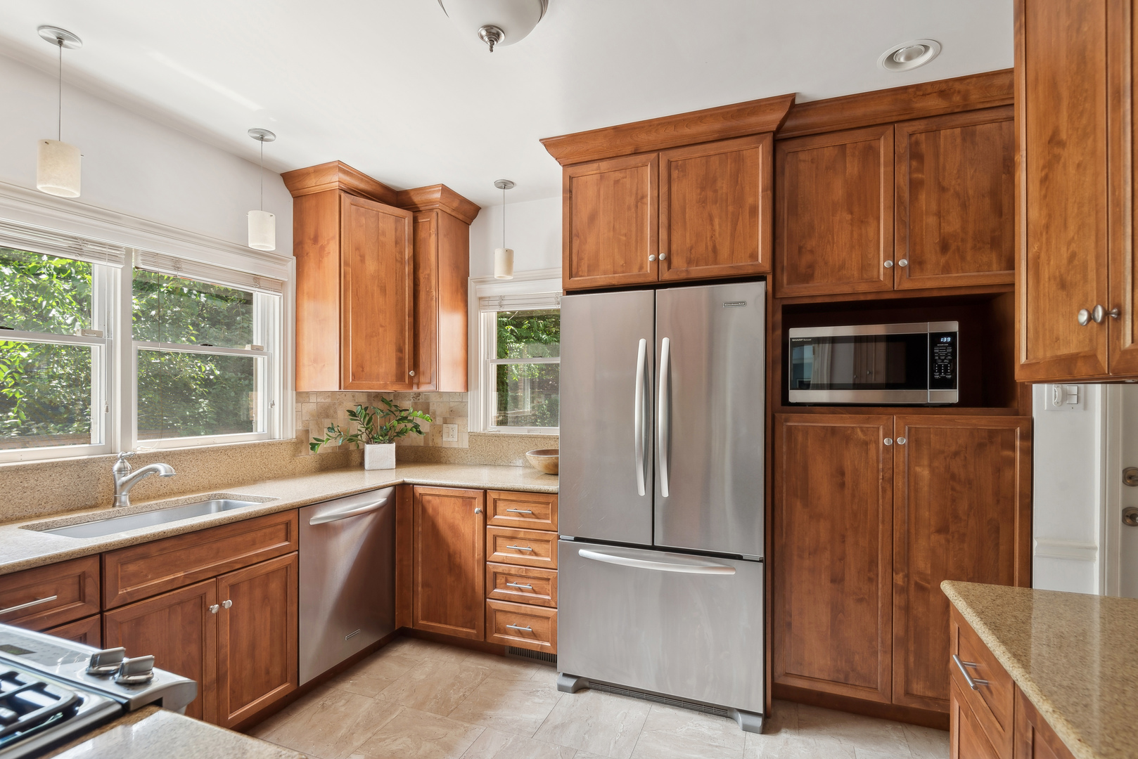 1249 Ridge Road Wilmette, IL 60091 - Photo 14 of 43 a kitchen with stainless steel appliances granite countertop a refrigerator a sink a stove and a microwave
