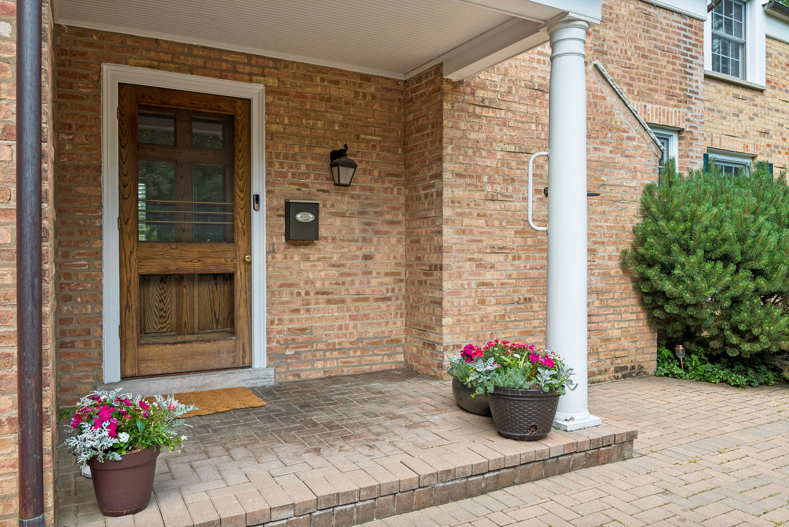 1249 Ridge Road Wilmette, IL 60091 - Photo 2 of 43 a potted plant sitting in front of a house