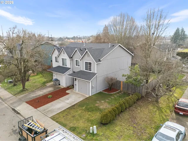 an aerial view of residential houses with outdoor space
