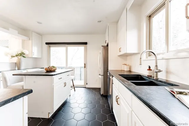 a kitchen with granite countertop a sink and cabinets