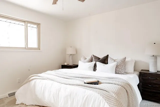 a bedroom with a bed and a large window