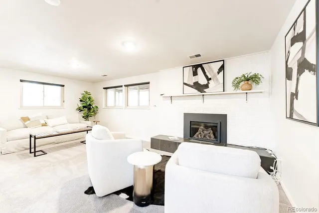 a living room with furniture and a potted plant
