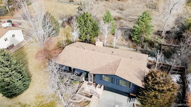 an aerial view of a house with a yard and garden