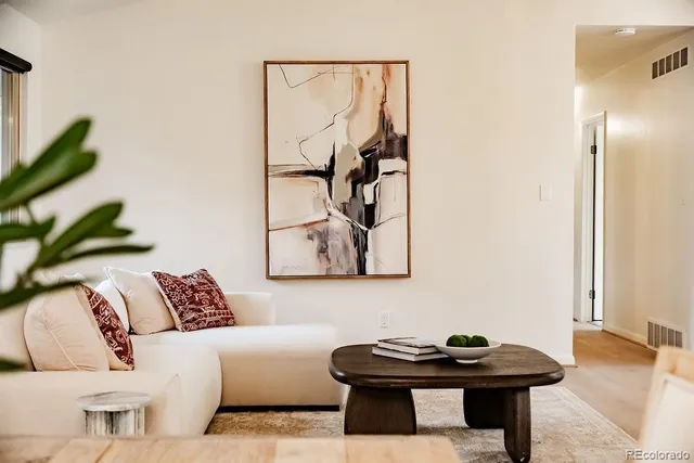 a living room with furniture and a potted plant