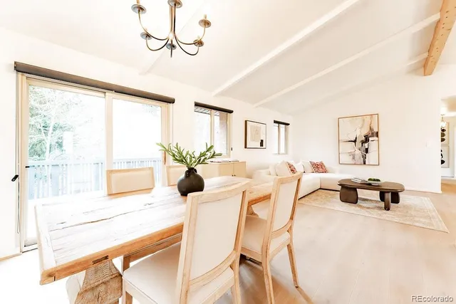 a living room with furniture and floor to ceiling window