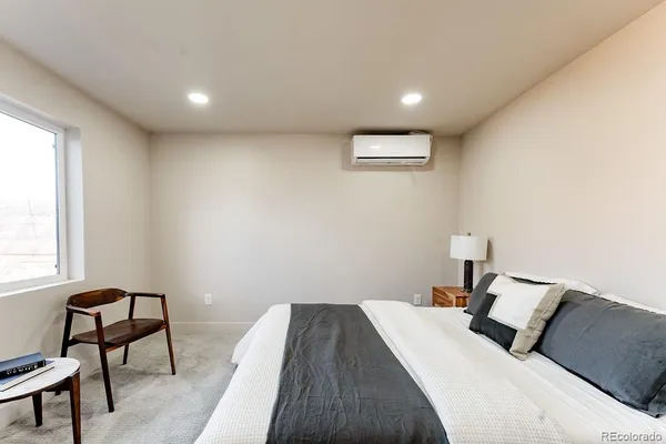 a bedroom with a bed and a chair