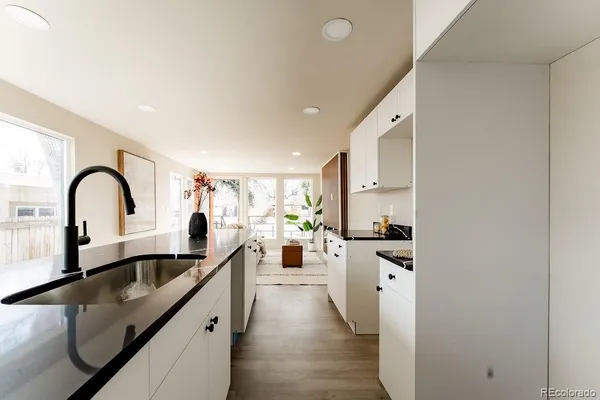 a large kitchen with sink a stove and cabinets