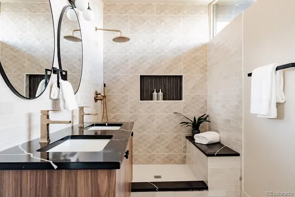 a bathroom with a sink a mirror and shower