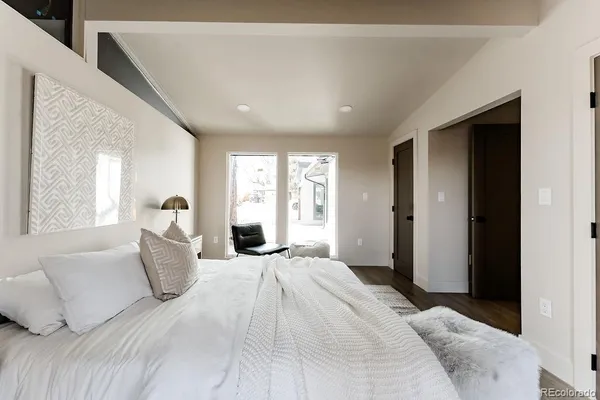 a bedroom with a large bed and a couch