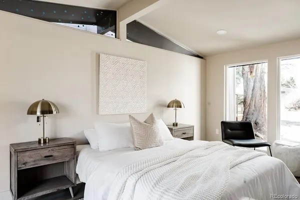 a bedroom with a bed and a lamp