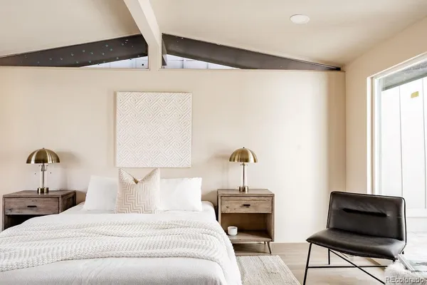 a bedroom with a bed and a window