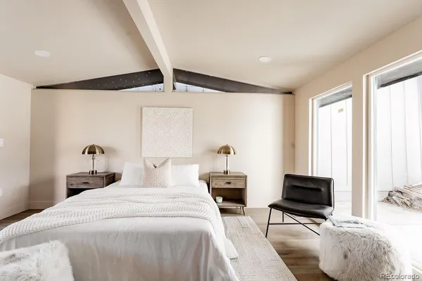 a bedroom with a bed and wooden floor