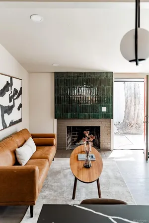 a living room with furniture a rug and a large window