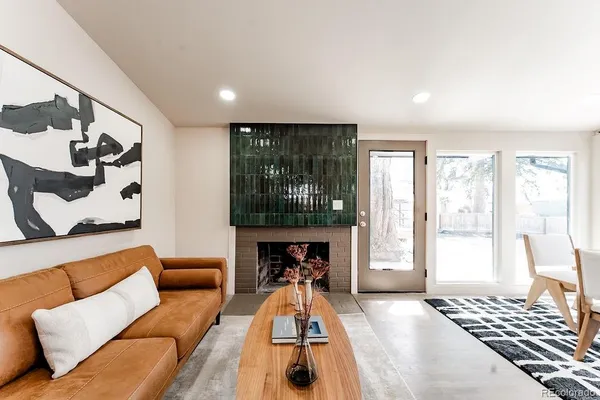 a living room with furniture and a fireplace