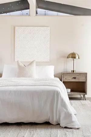 a bedroom with a bed and a night stand