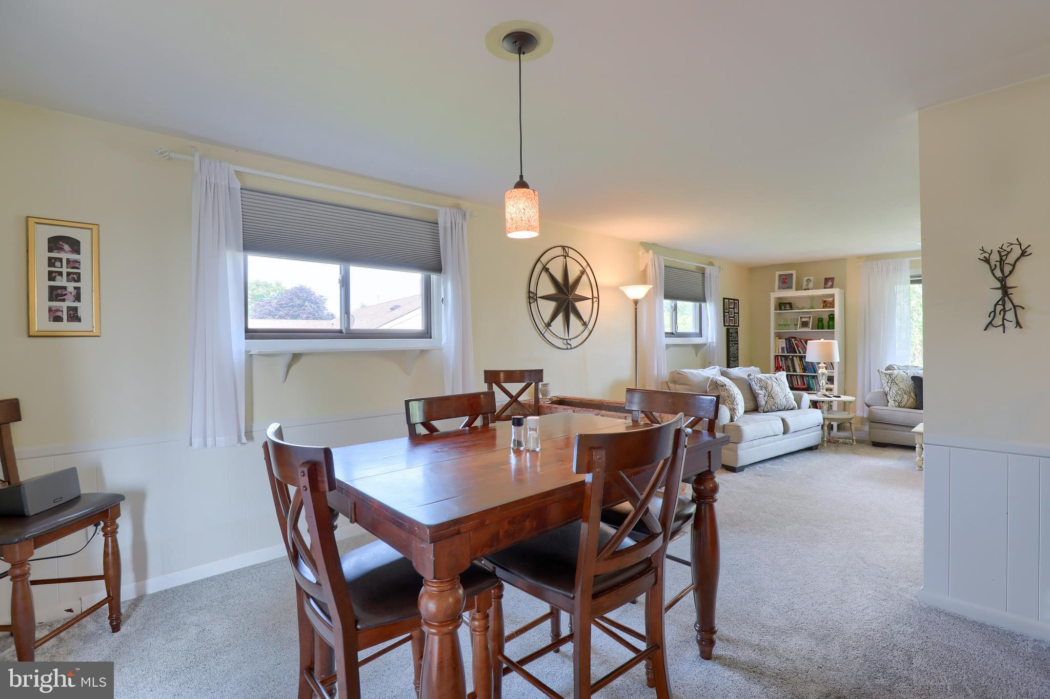 1307 Lookout Lane Lititz, PA 17543 - Photo 10 of 58 a view of a dining room and livingroom with furniture wooden floor a rug a painting and a chandelier